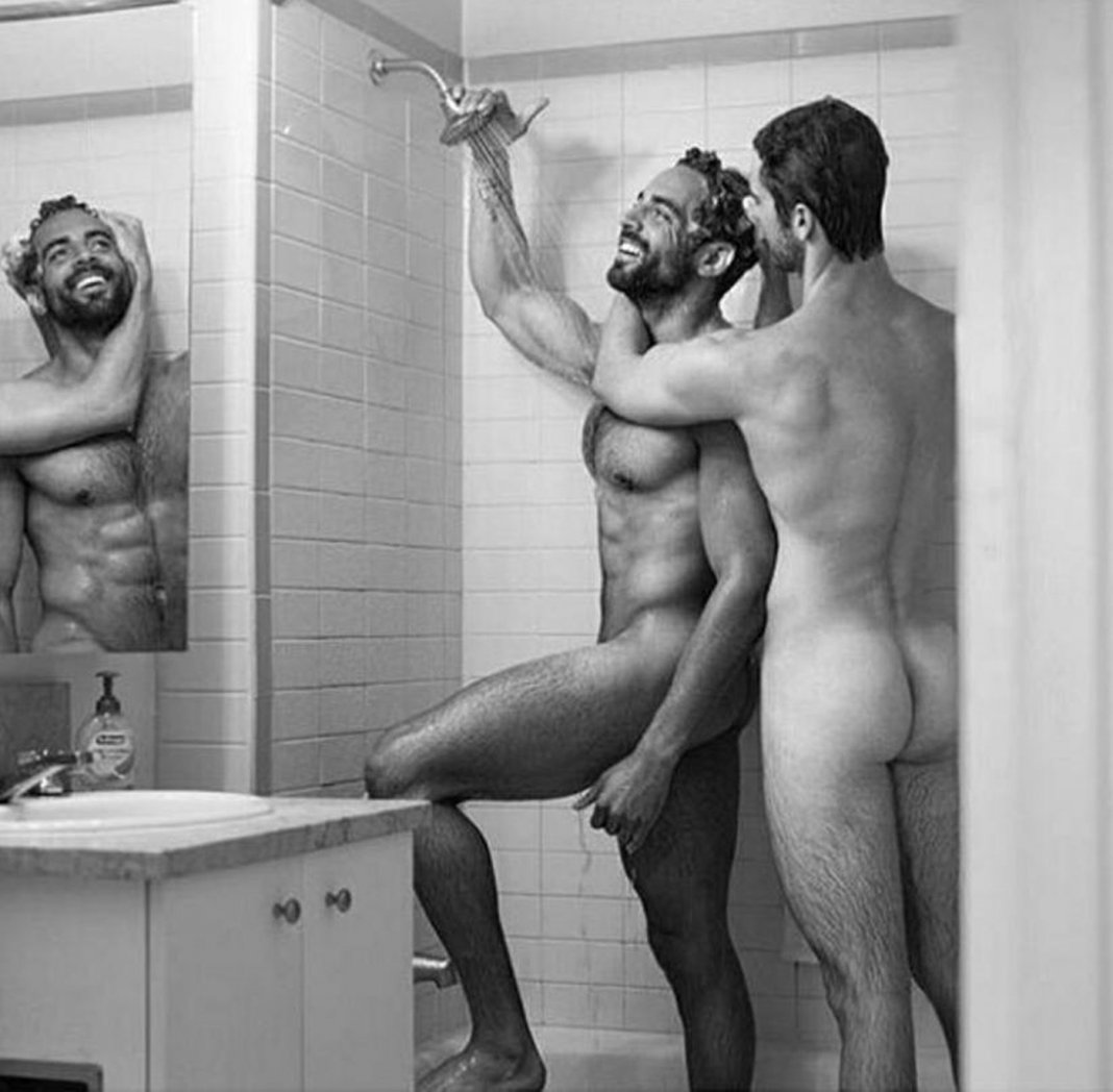 Nude lads comparing in the shower