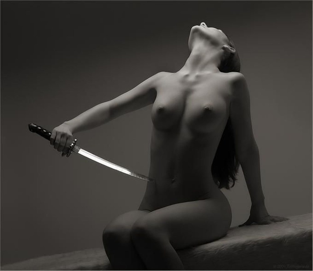 Erotic nude woman knife thrower's target